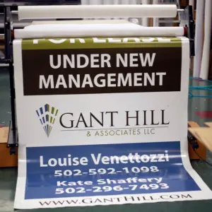 Custom printed business sign reading 'Under New Management' with company name and contact information