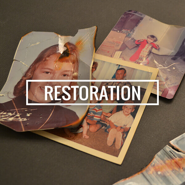 Damaged vintage photograph undergoing photo restoration process
