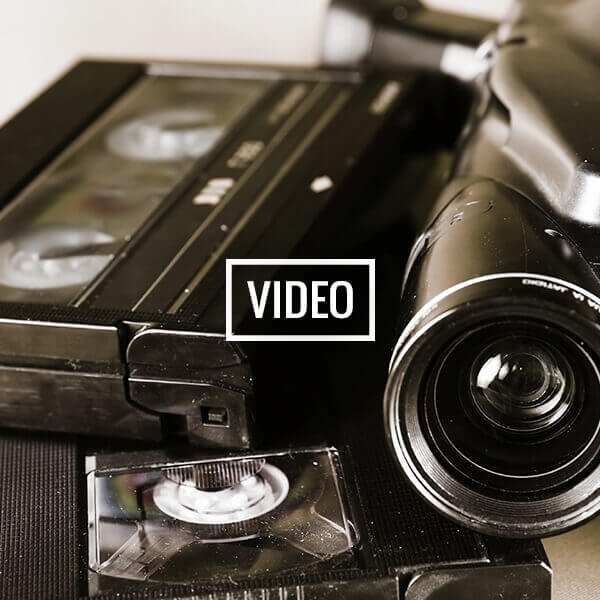 VHS tape and camcorder representing home video digitizing services