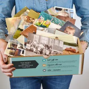 Gather archival box filled with printed photographs and family snapshots ready for scanning and preservation