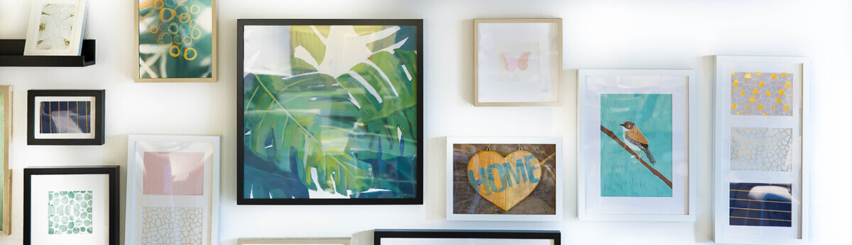 Framed artwork and prints arranged in a modern gallery wall display
