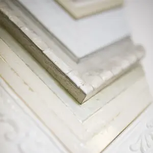 Close-up of layered white custom frame and matting detail on textured artwork