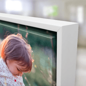 Framed photo print of a child displayed in a modern white frame