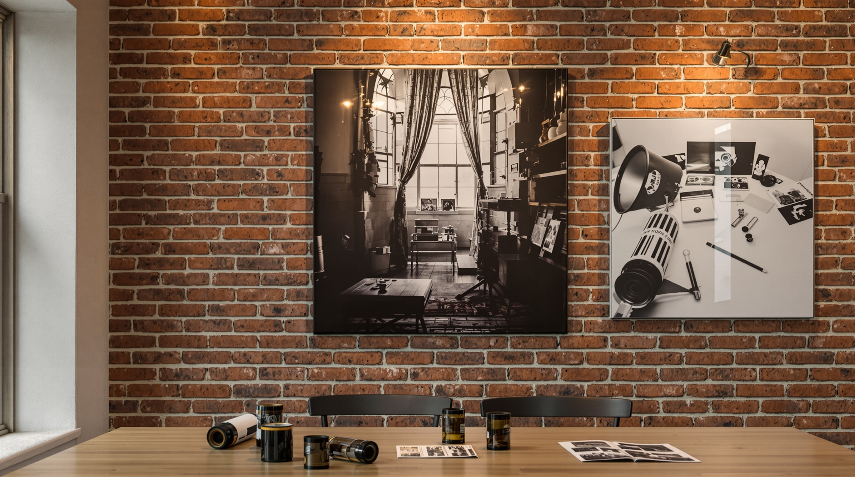 Louisville photography studio displaying canvas, metal, and acrylic prints of black-and-white film images with 35mm film roll and negatives on wooden table