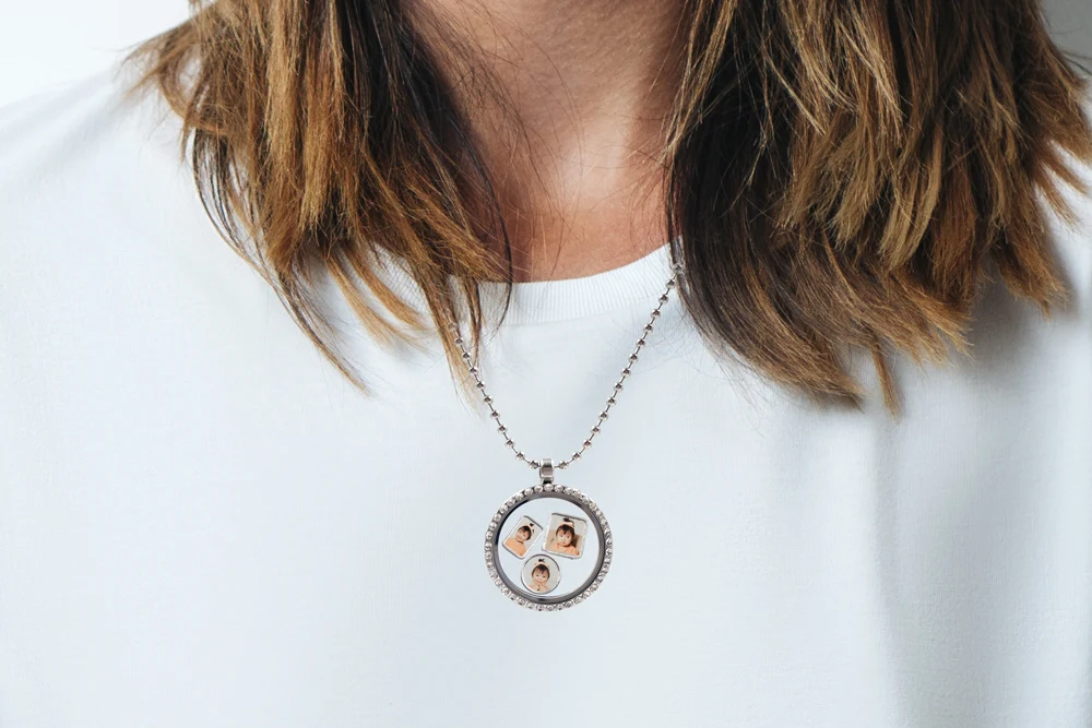 Floating locket necklace with three photo charms inside