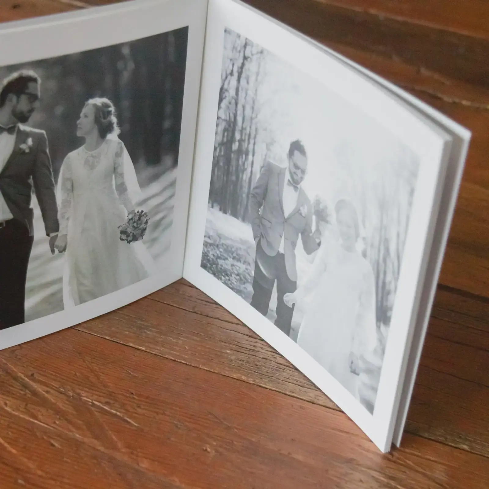 Softcover photo book open on table
