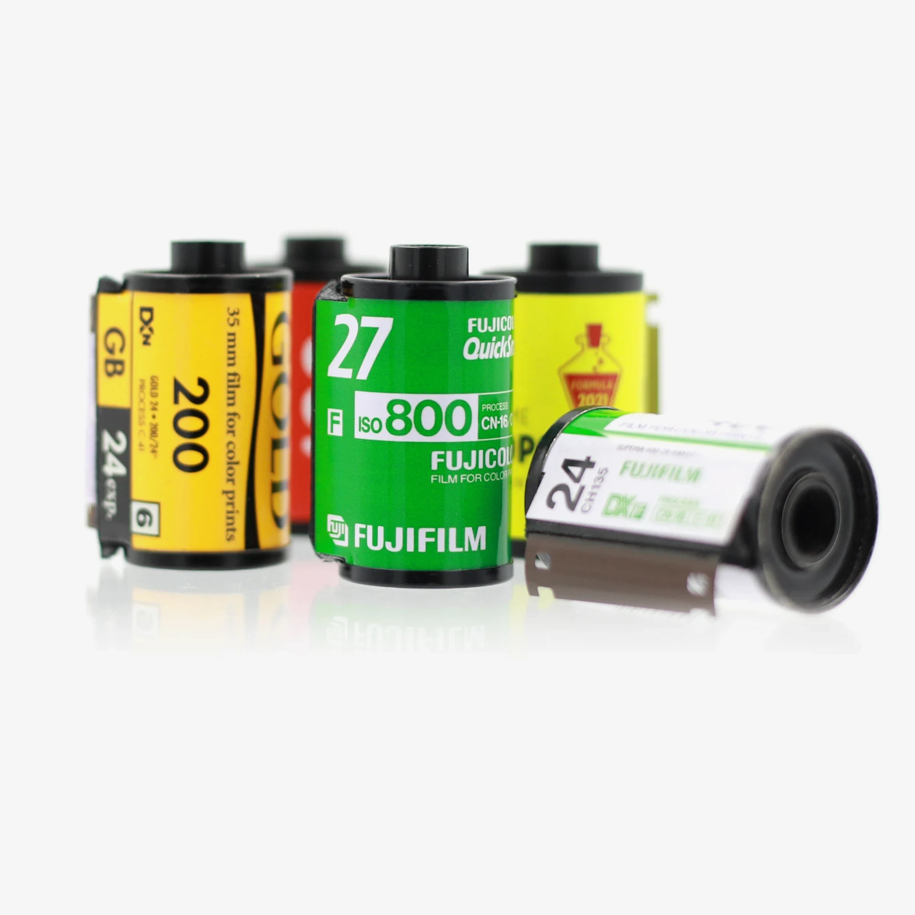 A vintage film camera surrounded by developed 35mm film negatives, representing analog photography and film processing