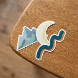 3 die cut vinyl stickers sitting on a table