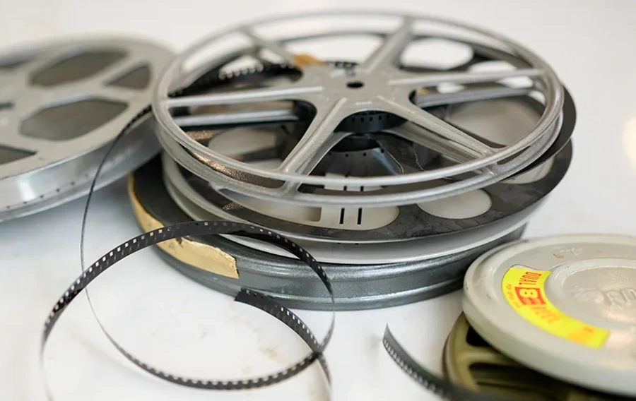 8mm, Super 8, and 16mm home movie film reels ready for digitizing at The Camera Shop Muskegon