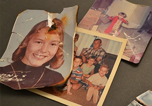 Before and after restoration of vintage military portrait showing crease and stain repair
