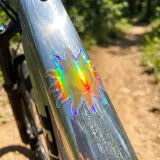 Holographic Sun die cut sticker on a bike
