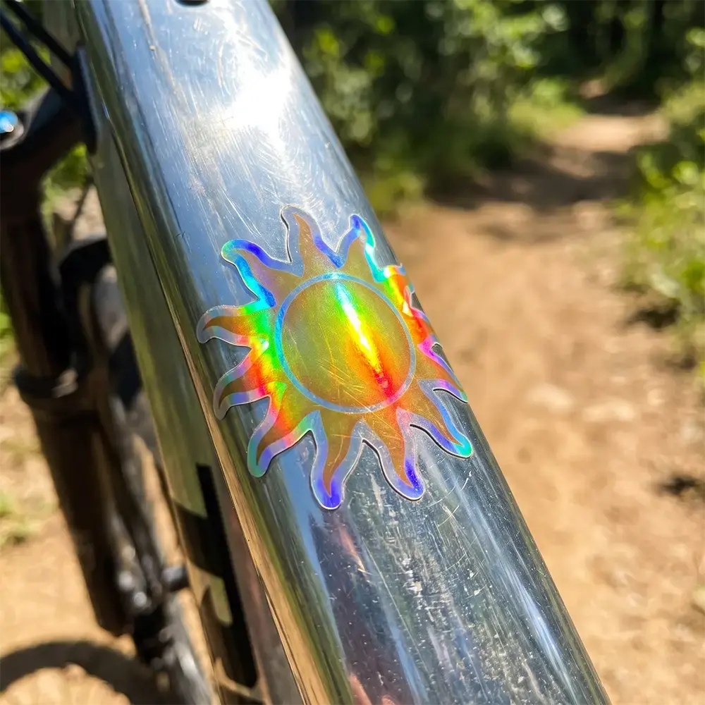 Holographic Sun die cut sticker on a bike
