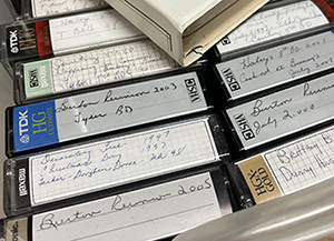 Box of aging VHS and video tapes ready to be converted to digital format