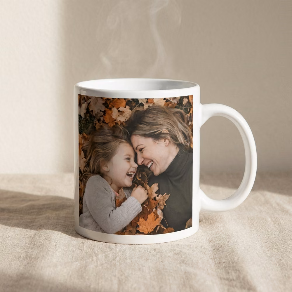 White photo mug printed with a mom and daughter in autumn leaves