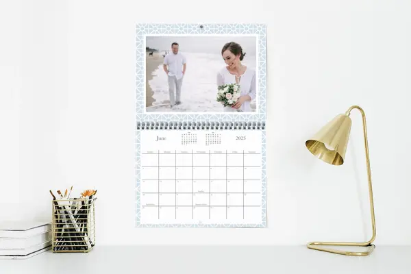 Custom photo calendar hanging on wall above desk