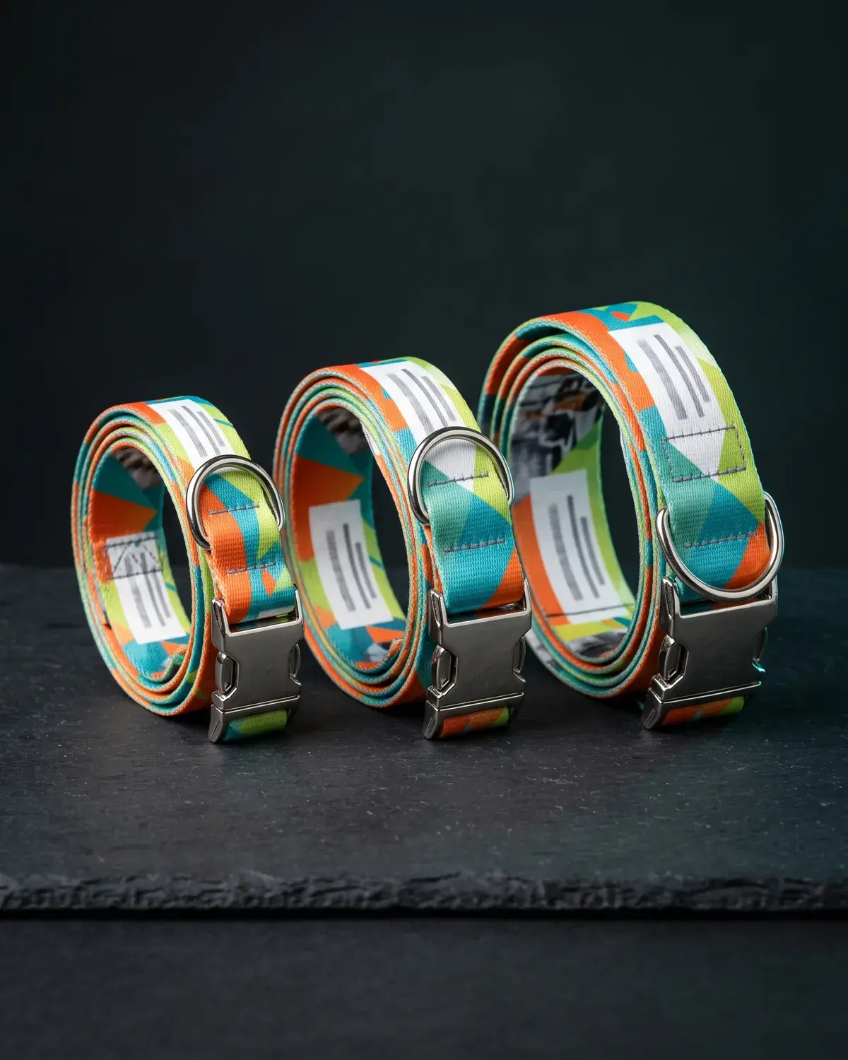 Three full color printed dog collars in small, medium and large.