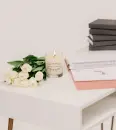 Dutch & Deckle Grapefruit Mint Scented Soy Lotion Candle burning next to white roses on white desk