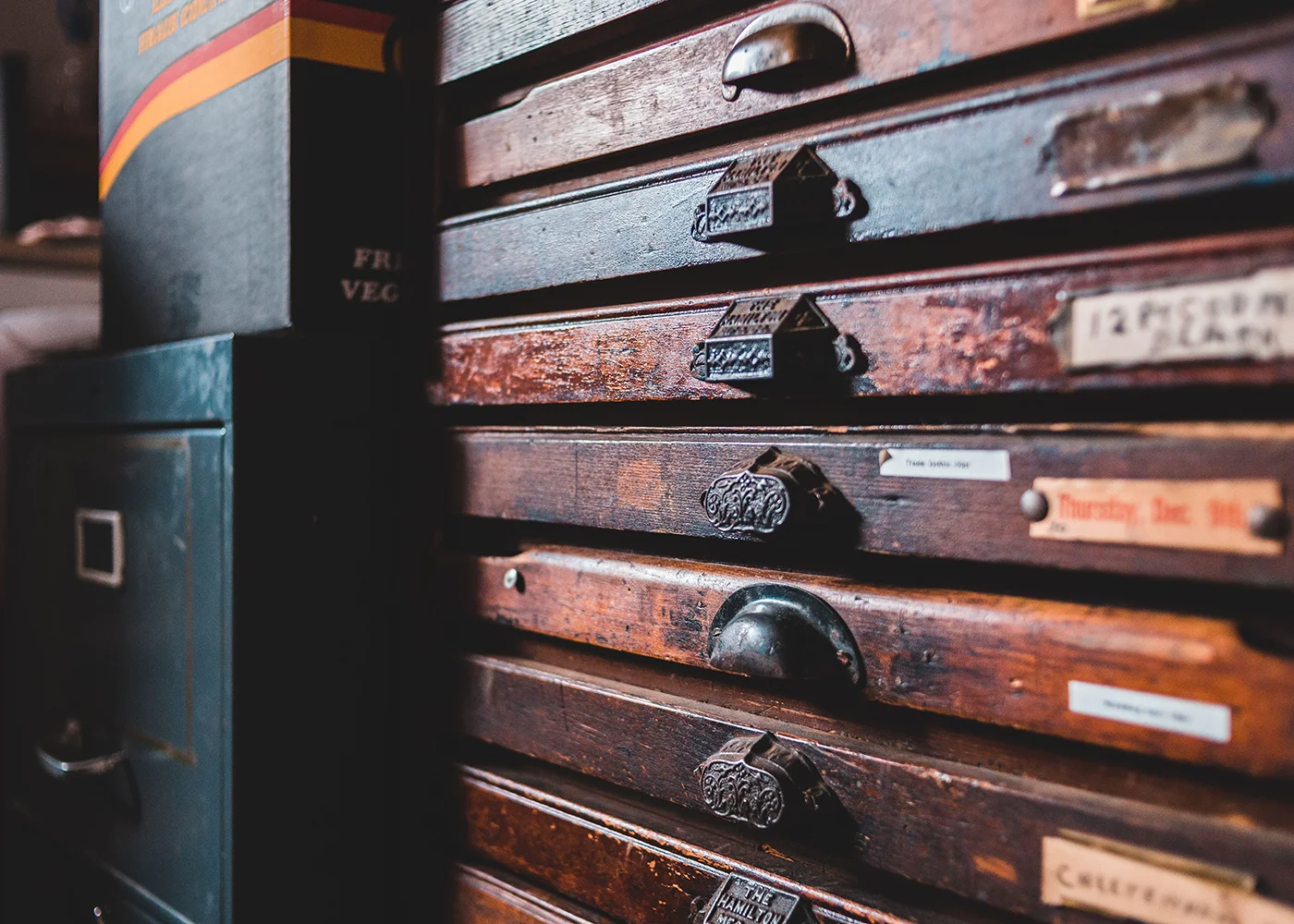 Antique wooden card catalog drawers with handwritten index labels