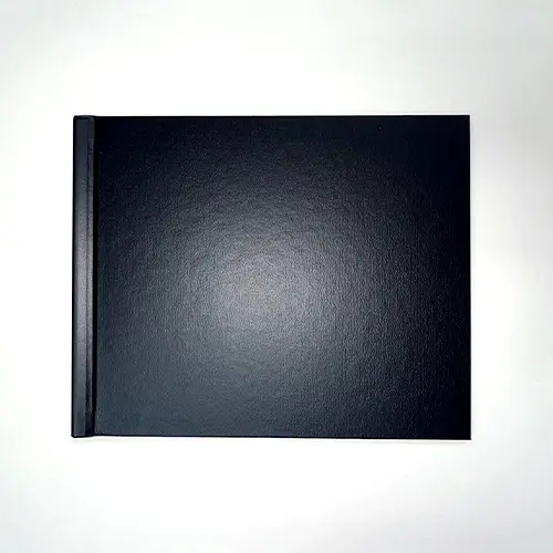 Black hardcover photo book with a landscape orientation, featuring a simple modern design and a smooth matte finish.