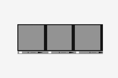 Close-up of photo film negatives and 35mm film rolls on a light gray surface, used for scanning or photo development services