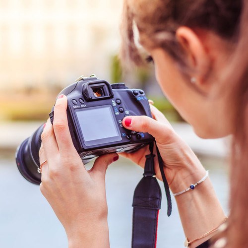 Woman adjusts camera settings during one on one photography class in Sioux Falls