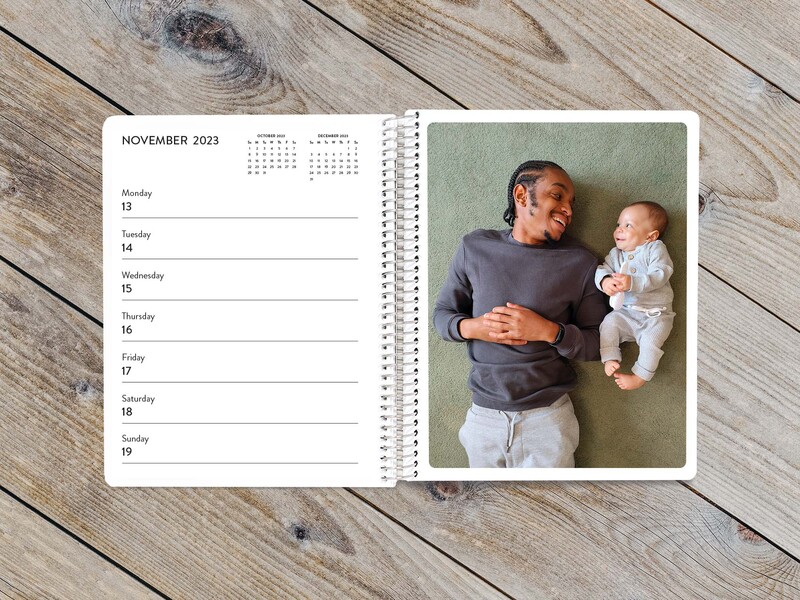 Desk calendar with an image of a smiling father with cute baby