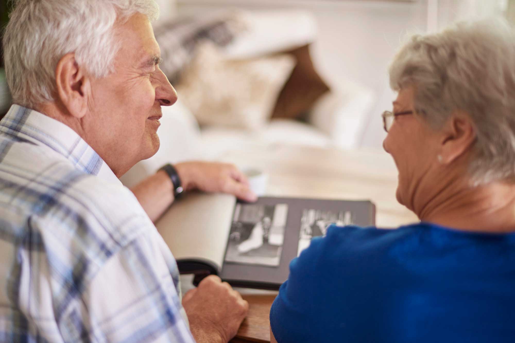 Grandparents Viewing Photo Planner Book With Grandchild